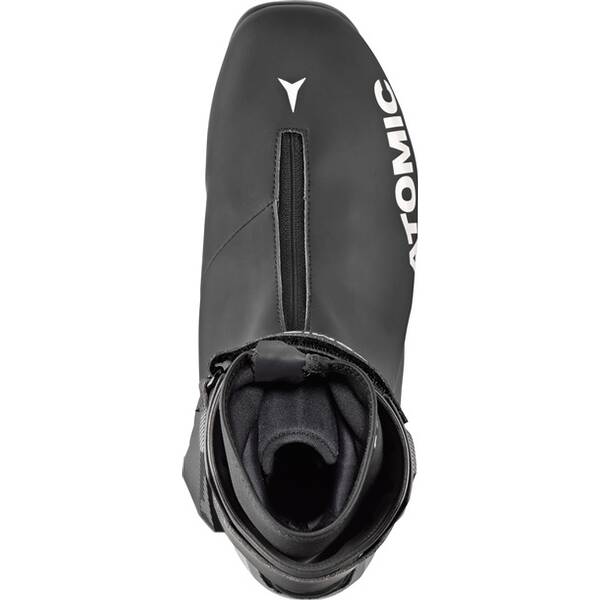 Top view of the Atomic Unisex Pro S2 Cross Country Ski Boot in black, featuring a center zipper, "ATOMIC" in white on the side, and a padded opening for an anatomical fit and enhanced comfort.