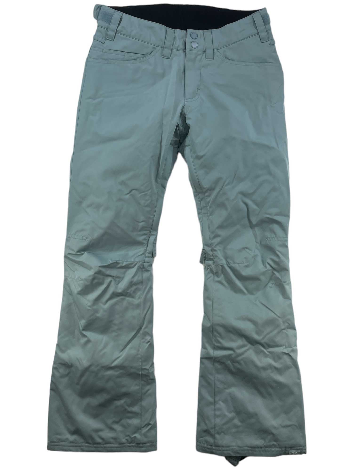 The Womens Backyard Snow Pants, in light gray, feature belt loops, front pockets, and a button closure. Made from breathable taffeta with a slightly wrinkled finish, they're shown laid flat on a white background.