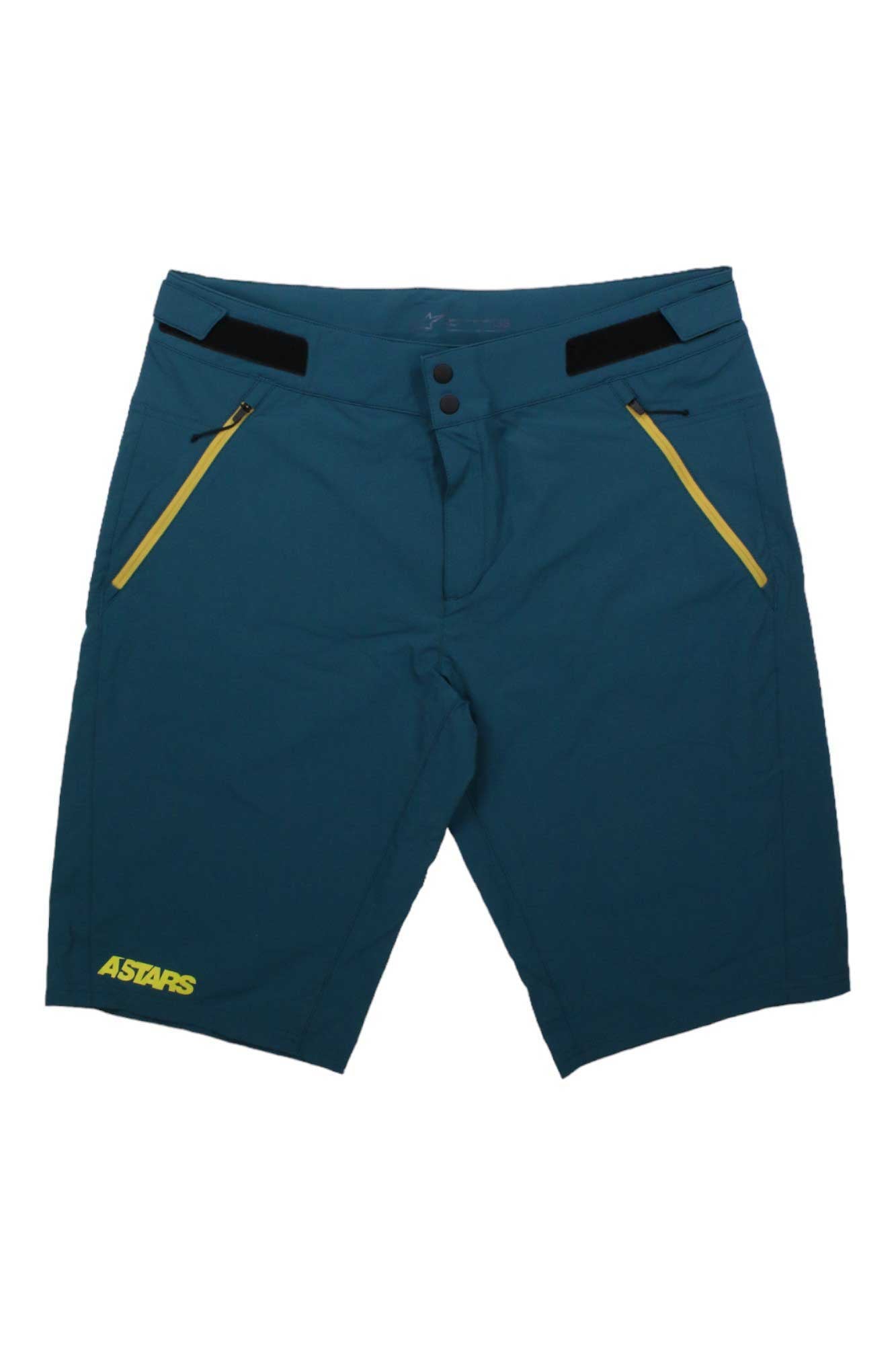 The AlpineStars Mens Rover Pro Short features teal stretch fabric, yellow zipper pockets, a yellow ASTARS logo on the left leg, and a button-and-zip waist closure for durability and style.
