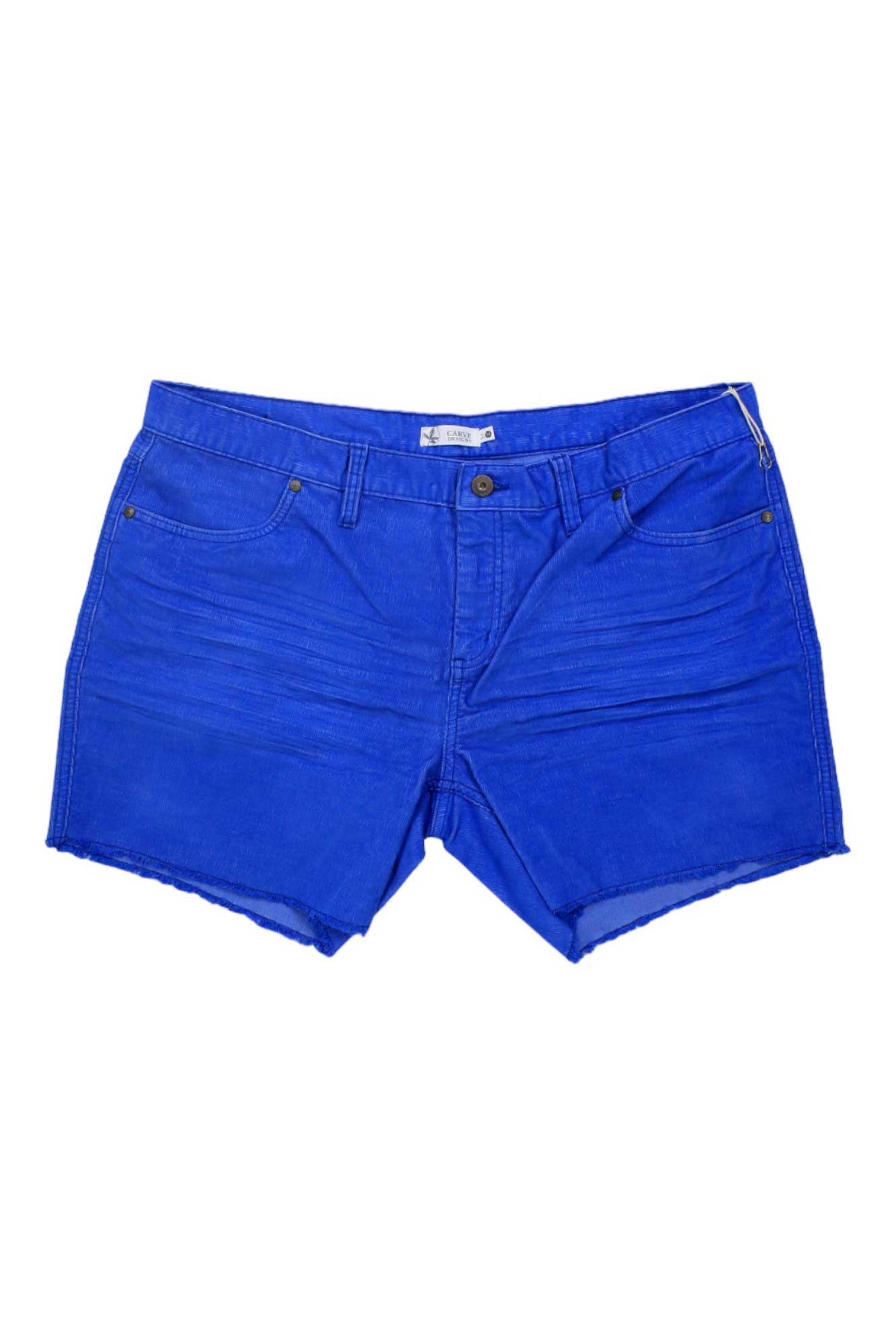 The Carve Designs Womens Oahu 6 Inch Short features bright blue organic cotton, raw frayed hems, front and back pockets, belt loops, and a button closure. Shown on a white background.