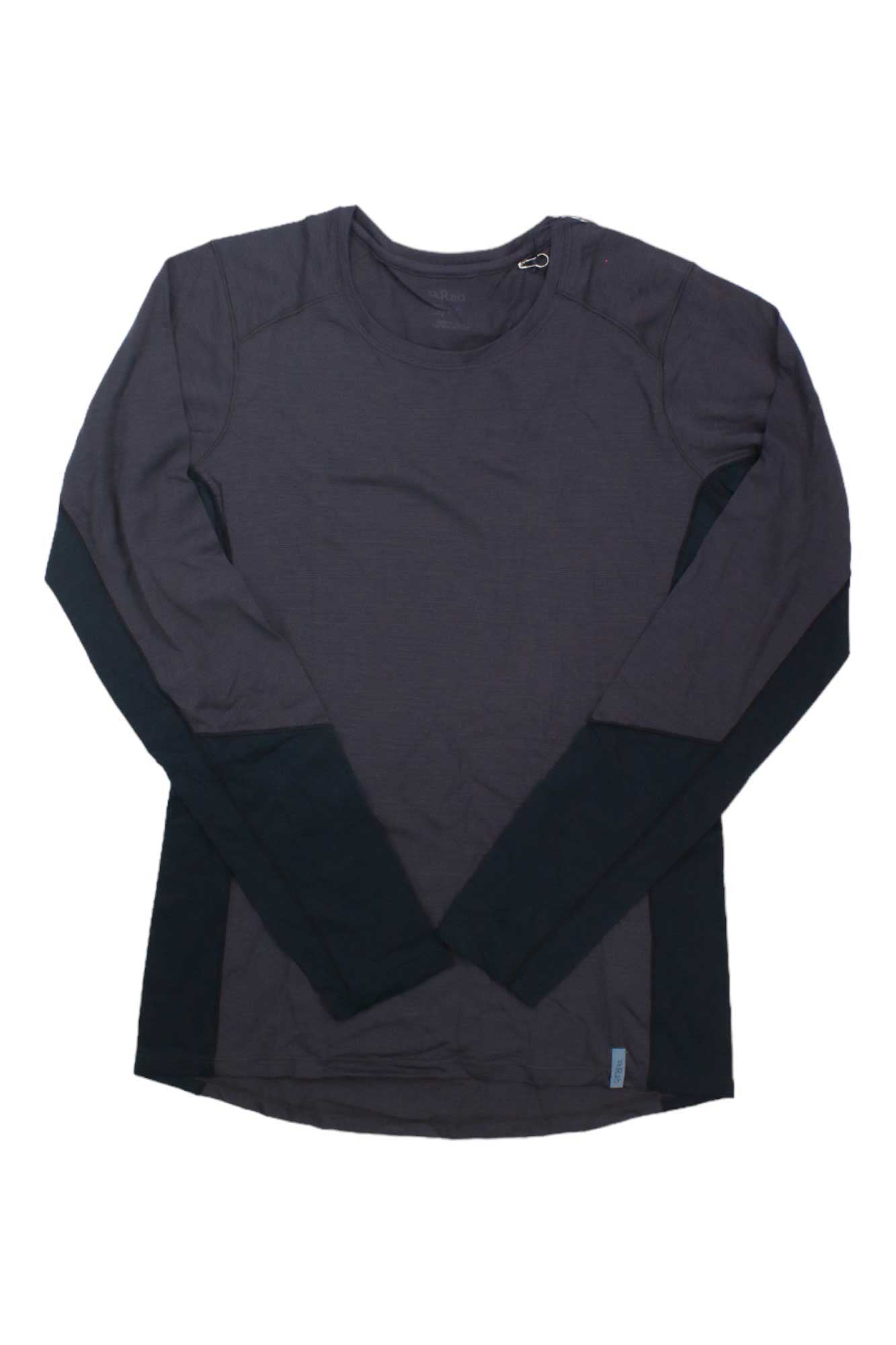 The Rab Womens Syncrino Base LS Tee is a long-sleeve, dark crewneck base layer for women with quick-drying fabric, lighter merino wool at the upper chest, and darker panels on the sides and lower sleeves, shown laid flat on a white background.