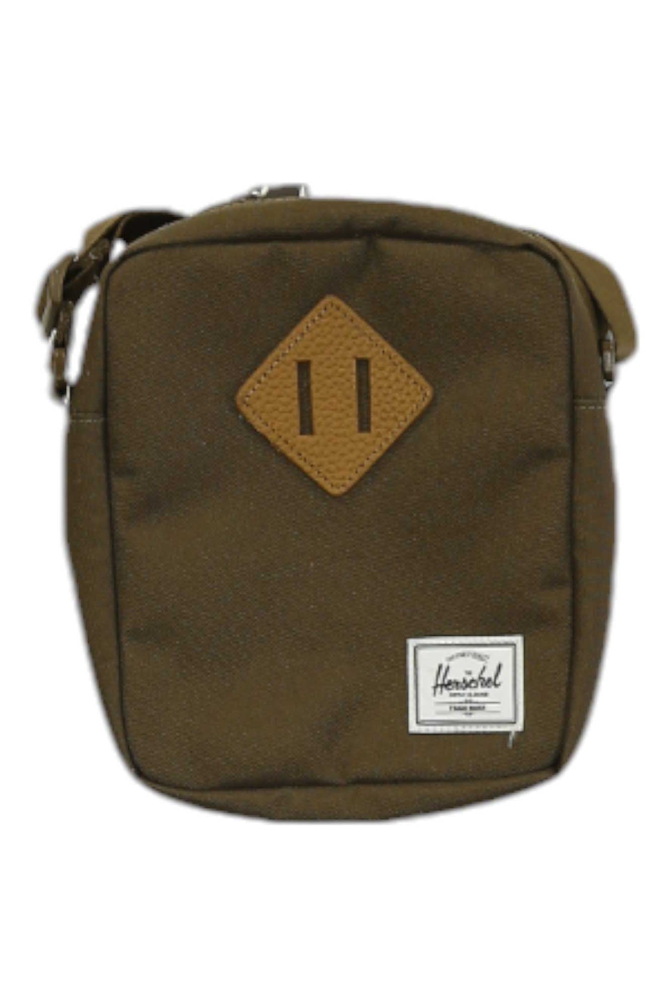 The Herschel Supply Company Heritage Crossbody Bag is a small, square unisex bag made from EcoSystem recycled fabric with an adjustable strap, tan diamond patch, and front logo label.