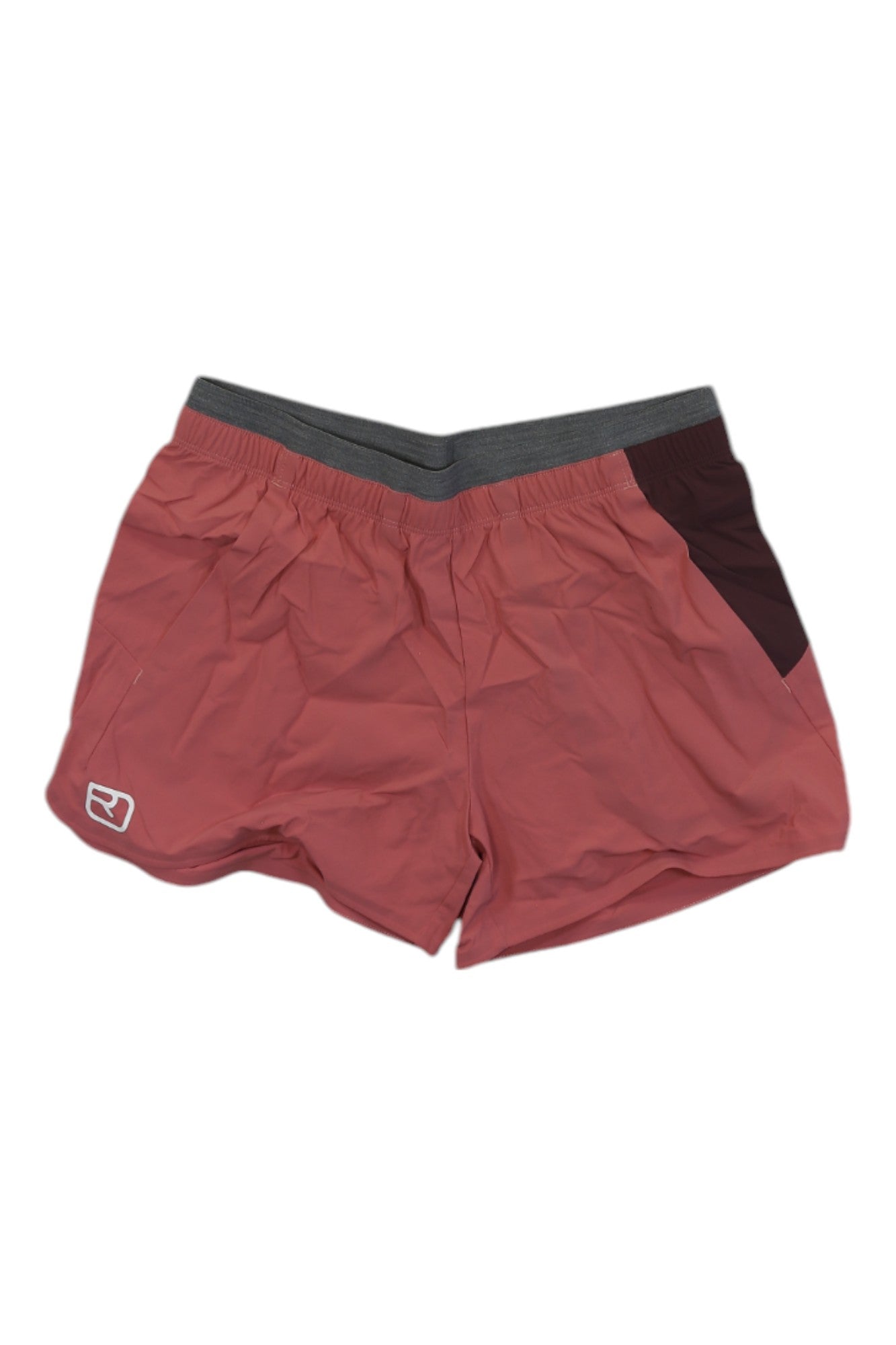 The Ortovox Womens Piz Selva Short features a coral pink design with a dark gray waistband, maroon accents, and a white logo on the lower left leg. These moisture-wicking athletic shorts are ideal for hiking and shown laid flat on a white background.