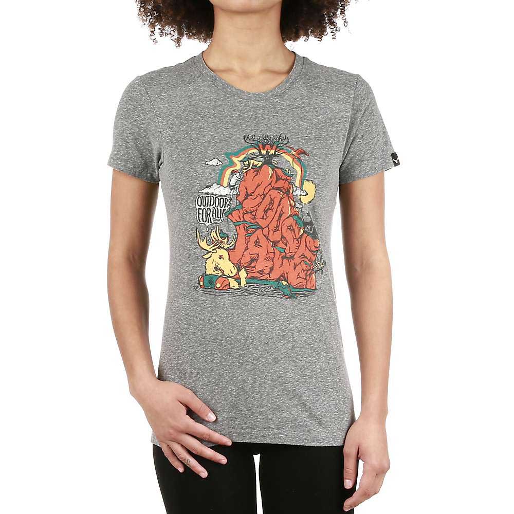 A woman wears the Moosejaw Womens Pizza Party SS Tee, a vintage washed short sleeve with a colorful mountain, sun, trees, and moose graphic plus "Outdoor Coral" text, standing casually with one hand on her hip.