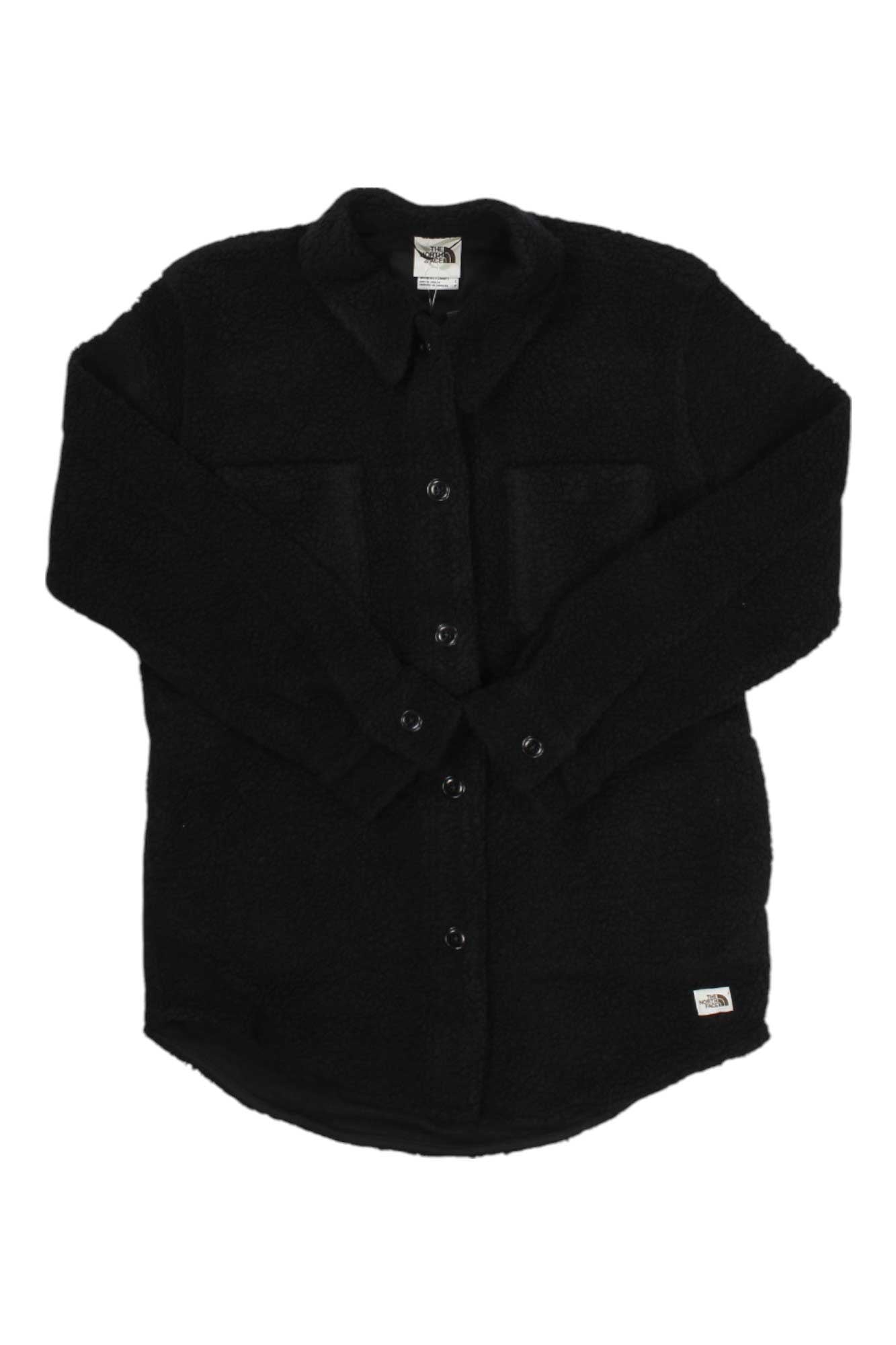 The North Face Womens Wool Harrison Shacket is a black, long-sleeve fleece wool shirt jacket with two chest pockets and a small white logo tag near the hem, shown on a white background.