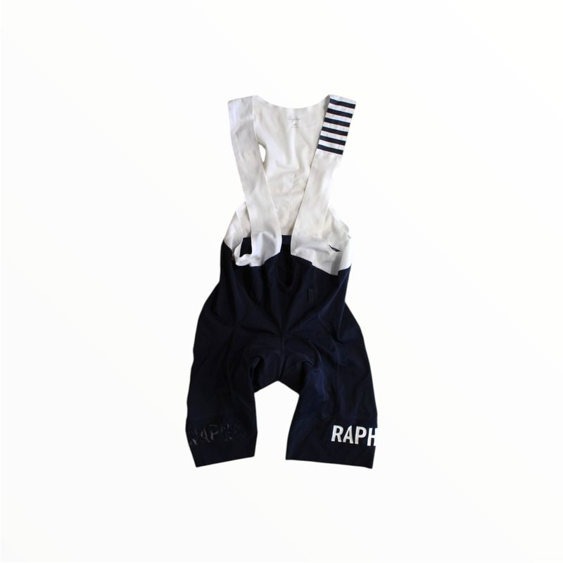 The Rapha Mens Pro Team Bib Shorts II - Regular, with race-grade chamois and RAPHA branding on the legs, shown against a plain white background.