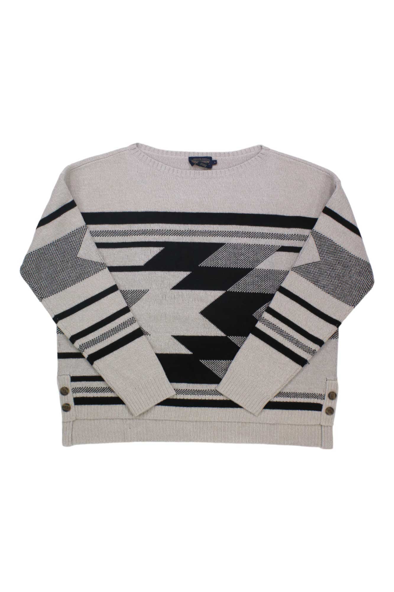 The Pendleton Women's Side Button Merino Sweater is a beige merino wool top featuring black geometric zigzag and horizontal stripes, long sleeves, and decorative side buttons for a stylish, casual look.