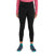 A person wearing a long-sleeve pink top, Icebreaker Womens Merino Speed Winter Tight in black, and teal and black athletic shoes stands against a plain white background. The image shows them from shoulders to feet.