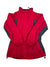 The Columbia Womens Old School Ski Jacket is red with black and gray accents on the sides and sleeves, featuring a high collar and elastic cuffs, shown on a white background.