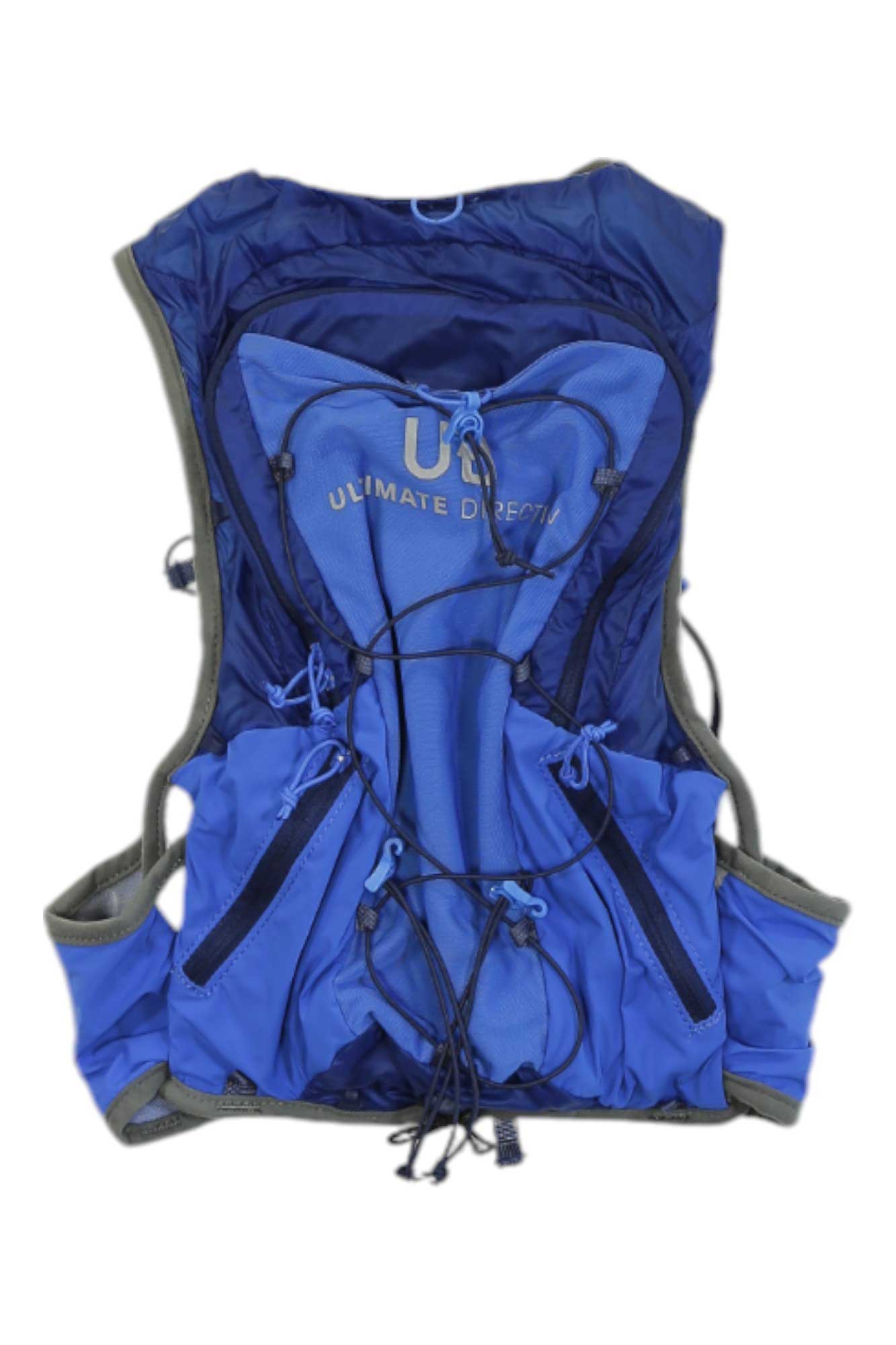 The Ultimate Direction Ultra Vest 6.0 is a blue hydration vest featuring multiple front pockets, elastic bungee cords, and rear branding—ideal for carrying water and essentials during outdoor activities or as an ultra running vest.