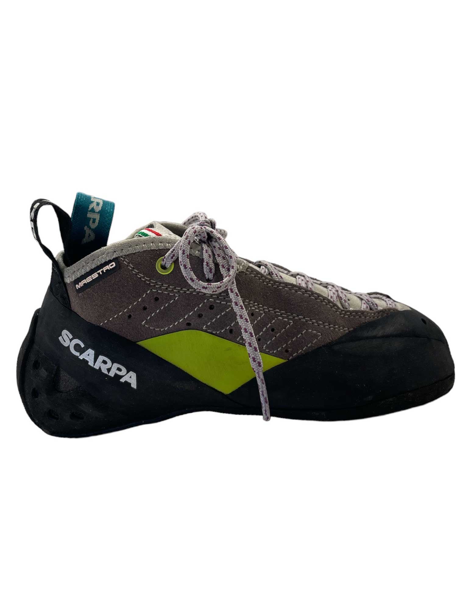 The Scarpa Women's Maestro Mid Climbing Shoe, featuring a gray upper with green accents, black toe and heel, white and gray laces, and a black rubber sole, is shown from the side against a white background.