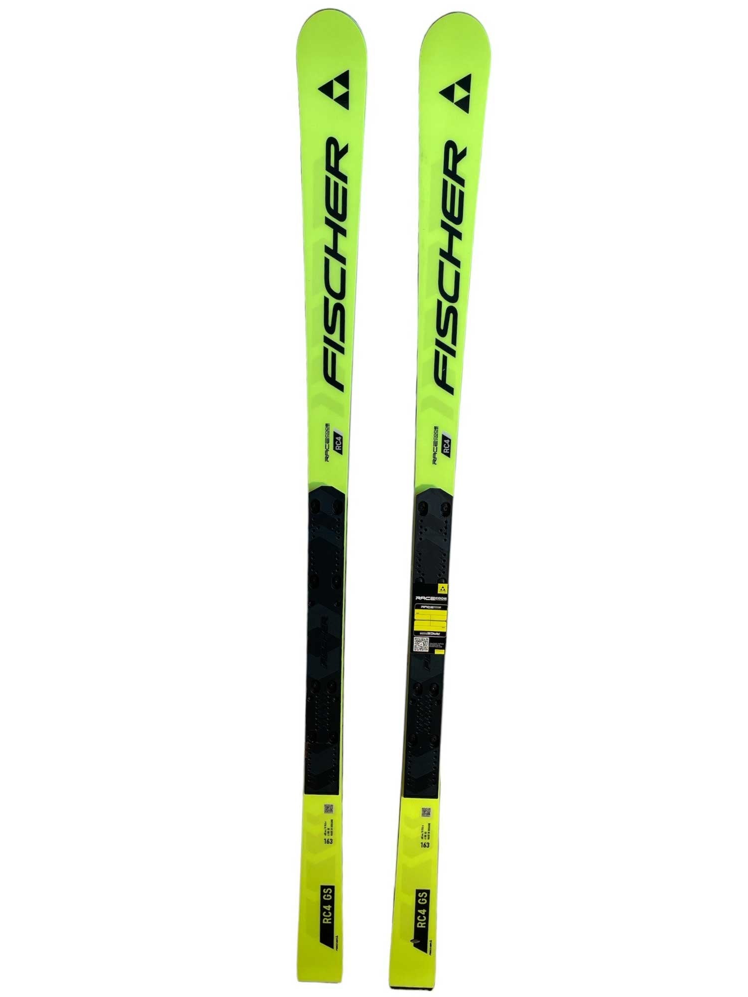 A pair of bright yellow Fischer Juniors RC4 Worldcup GS M-Plate Skis with black details and the Fischer logo, designed for Giant Slalom racing, displayed side by side on a white background.