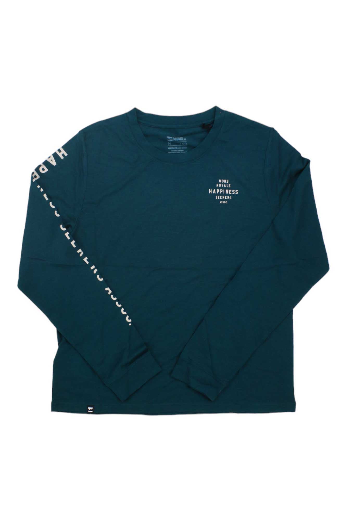 The Mons Royale Womens Icon Relaxed LS Tee is a long sleeve, dark teal Merino Wool crew neck with "MORE HAPPINESS PLEASE" in white on the left chest and partial white print on the right sleeve—ideal for hiking or daily comfort.