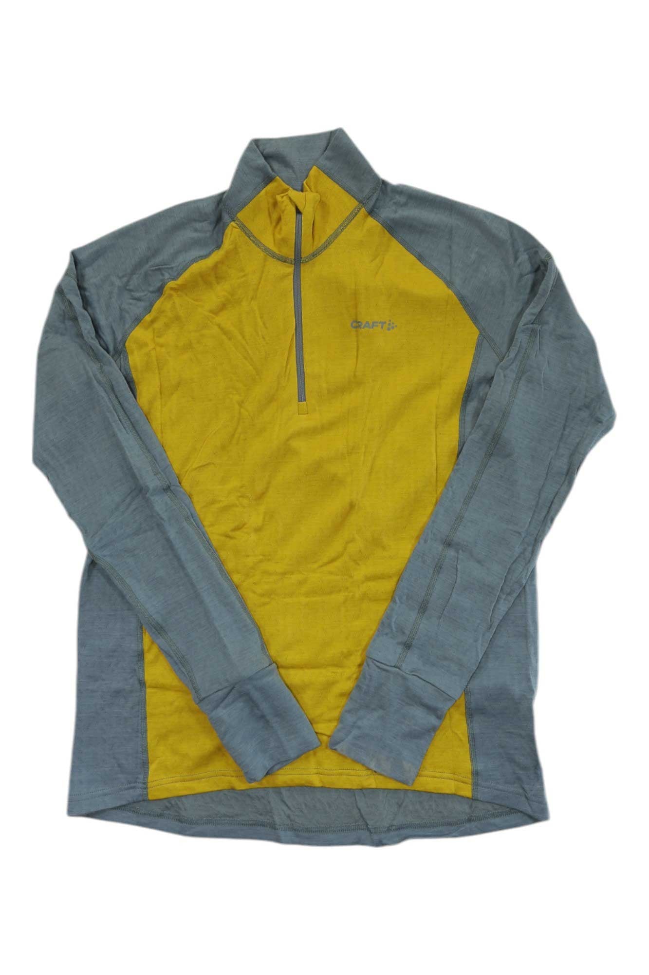 The Craft Sportswear Men's Adv Nordic Wool Half Zip Top features a yellow front panel, gray sleeves and sides, moisture-wicking fabric, a short front zipper, and the Craft logo on the chest.