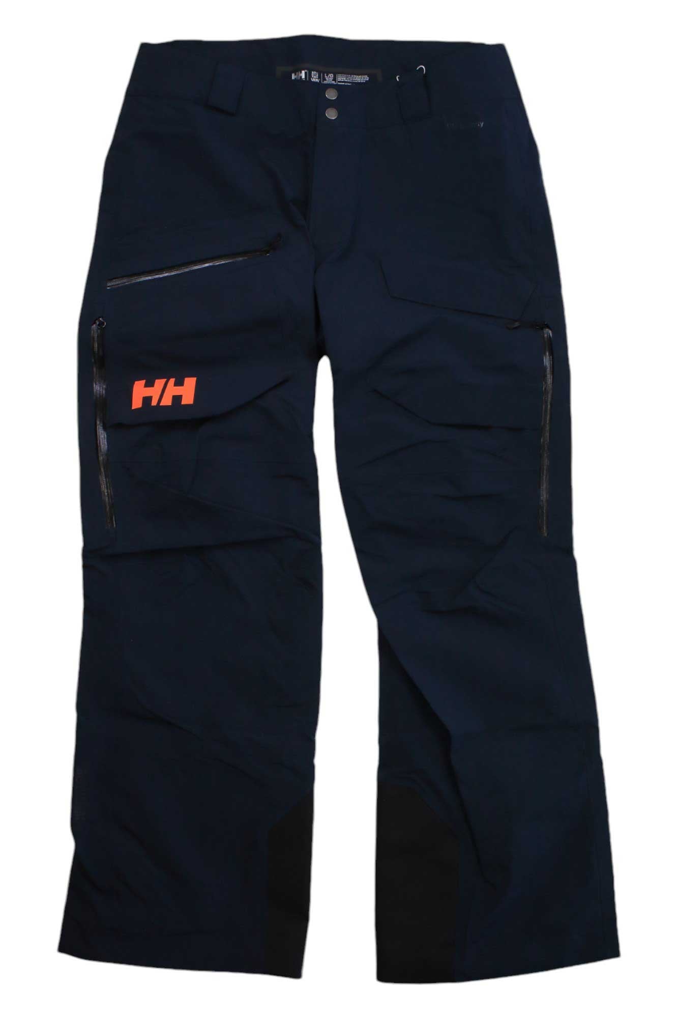 Helly Hansen Mens Ridge Infinity Shell Pant in navy blue with zippered pockets, reinforced knee patches, and an orange HH logo on the left thigh.