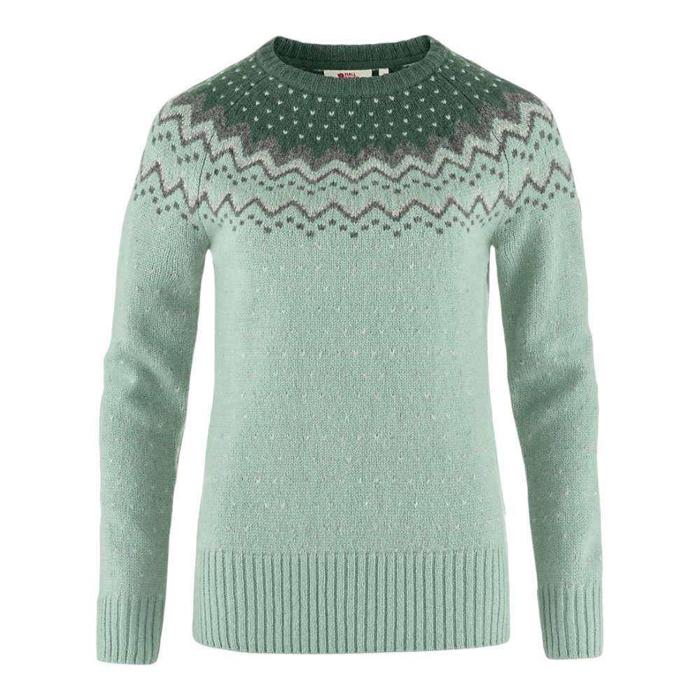 The Fjallraven Womens Ovik Knit Sweater in light green features a round neckline, long sleeves, ribbed hem, cuffs, and collar, plus a white and dark green zigzag and dot pattern across the chest—perfect for hiking comfort.
