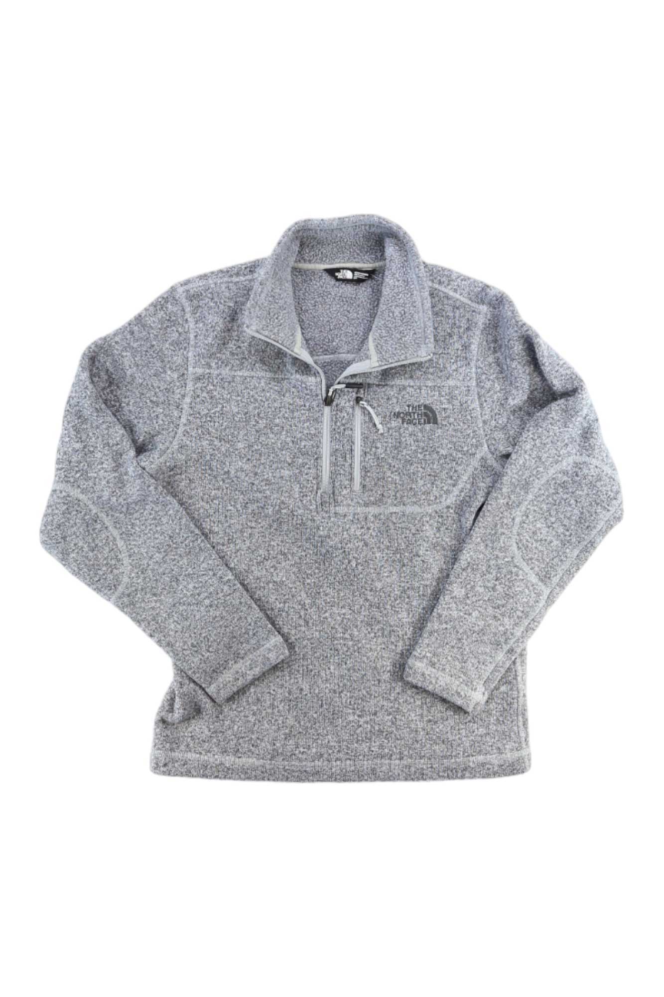 The North Face Gordon Lyons 1/4 Zip is a heather gray men's fleece jacket with a quarter-zip front, chest pocket, and sweater-knit zip made from recycled polyester. The logo appears on the left chest. Shown laid flat on a white background.