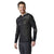 A man with short brown hair and a beard smiles, wearing the Smartwool Mens Intraknit Merino 200 1/2 Zip Hoodie with grey accents and dark leggings, ideal for men’s snowsports, standing against a plain white background.