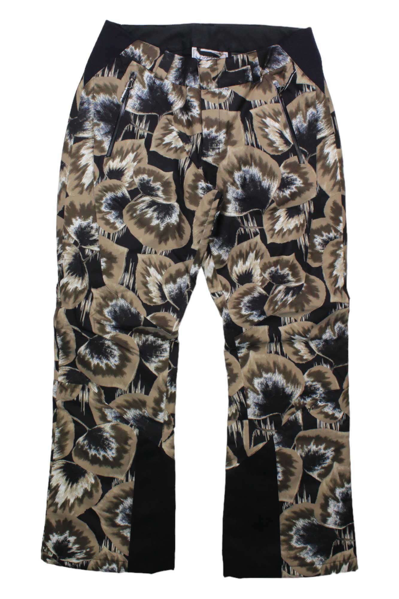The Spyder Womens Winner Pant features a bold abstract floral print in brown, beige, black, and white, with black side panels, front zip pockets, and PrimaLoft insulation—perfect for warmth and style on the slopes.