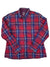 The Womens Two Pocket Button Up is a long-sleeved plaid shirt with red, blue, and white stripes, two chest pockets, and a collar—perfect for everyday wear.
