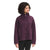 A woman with curly hair wears The North Face Womens Ridge Fleece Full Zip Jacket in dark purple, featuring large front pockets. She stands facing left, smiling slightly, against a plain white background.