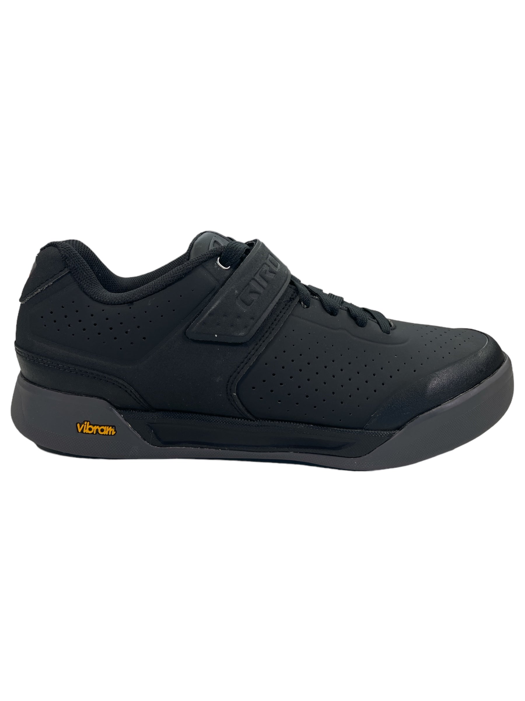 The Giro Chamber II Cycling Shoe is a black, low-top athletic shoe with a lace-up front, perforated side, and hook-and-loop strap. Its gray outsole sports a yellow Vibram logo near the heel for traction and pedal power on trails.