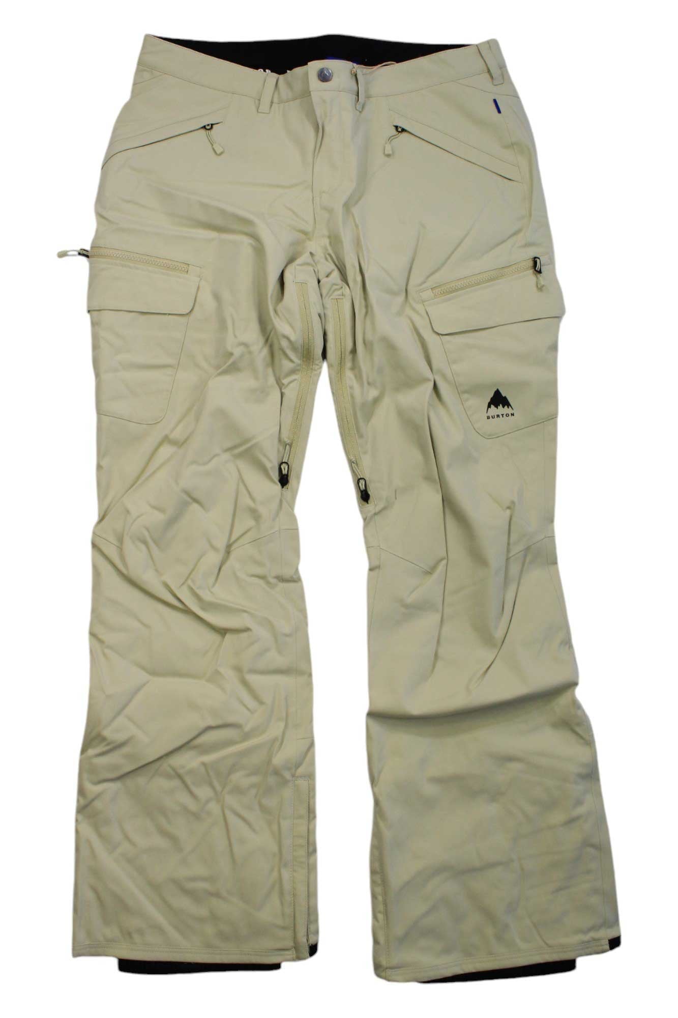 Burton Womens Gloria Insulated Pant in beige features waterproof fabric, a slim fit, multiple zippered pockets, reinforced knees, belt loops, and a small mountain logo on one leg. Shown laid flat on a white background.