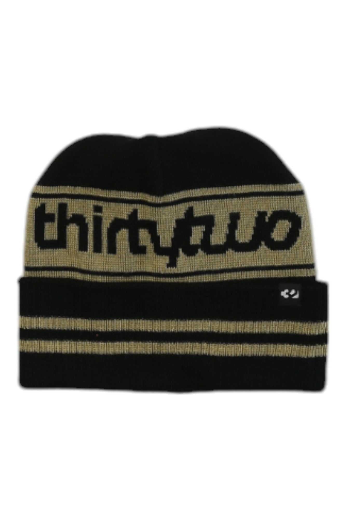 The Thirty Two Double Beanie is a black ribbed knit beanie with tan stripes, "thirtytwo" knitted in tan on the front, and a black-and-white logo tag. Made from recycled acrylic for eco-friendly style.