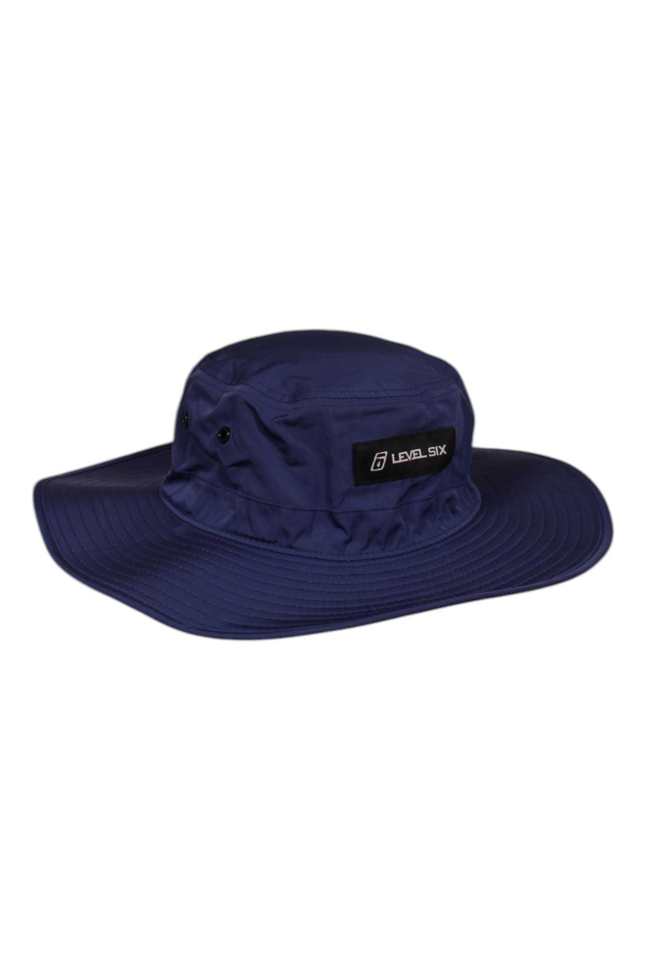 The Level Six Prospector Hat is a wide-brimmed, dark blue outdoor hat featuring a Level Six patch and side ventilation eyelets, designed to provide excellent sun protection for all your adventures.