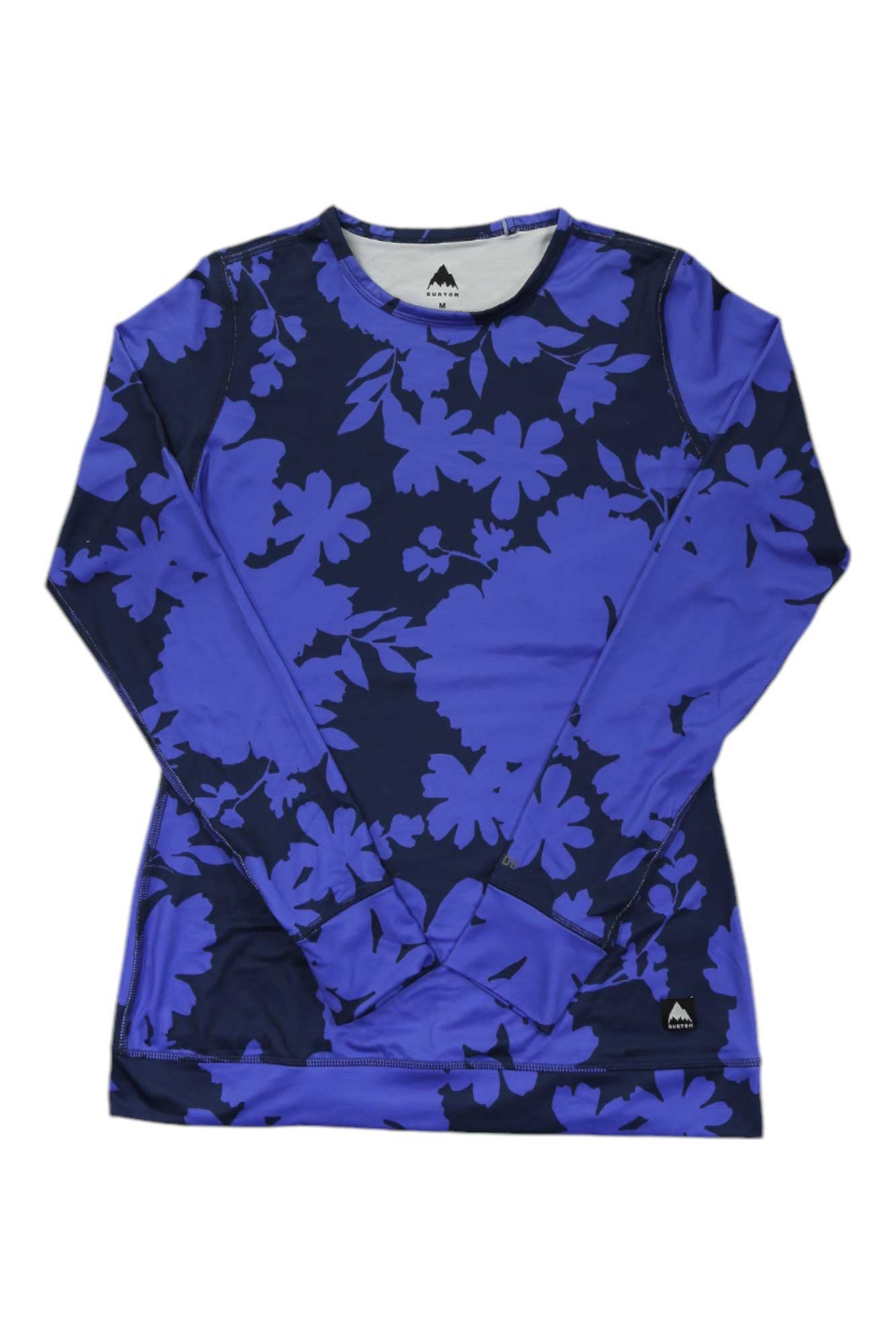 The Burton Womens Midweight Base Layer Crew is a long-sleeve shirt with a navy and purple floral print, crew neck, subtle logo near the hem, and DRYRIDE Ultrawick fabric for breathable comfort.