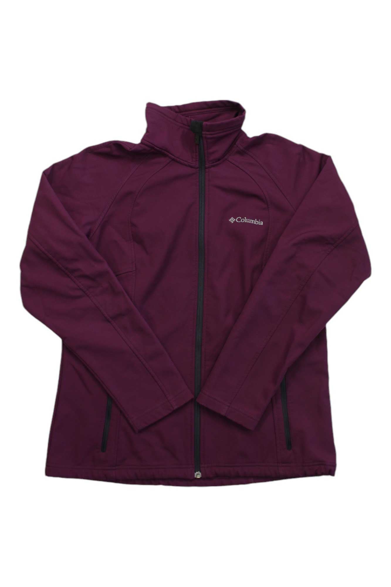 The Columbia Womens Soft Shell Jacket features a maroon color, long sleeves, front pockets, and a high collar. Designed for comfort with breathable soft shell fabric. Displayed on a white background.