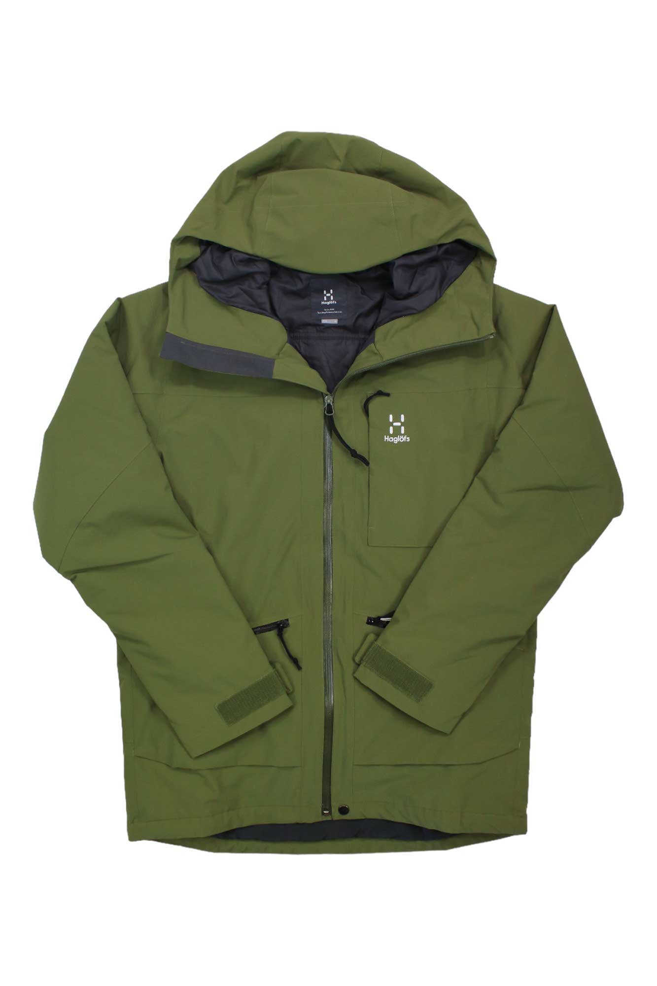 The Haglofs Men's Lumi Insulated Jacket is an olive green ski jacket with a front zipper, chest and lower pockets, black accents, a white logo on the left chest, and is designed to keep you warm in winter conditions.
