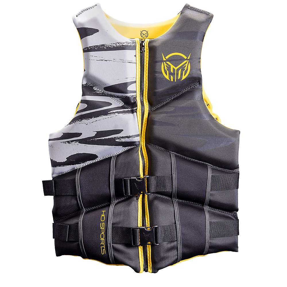 The HO Sports Mens Mission Vest is a black and gray life jacket with yellow accents, front zipper, two adjustable buckles, HO Sports logos on chest and side, stylish left-side pattern, and Coast Guard approval.