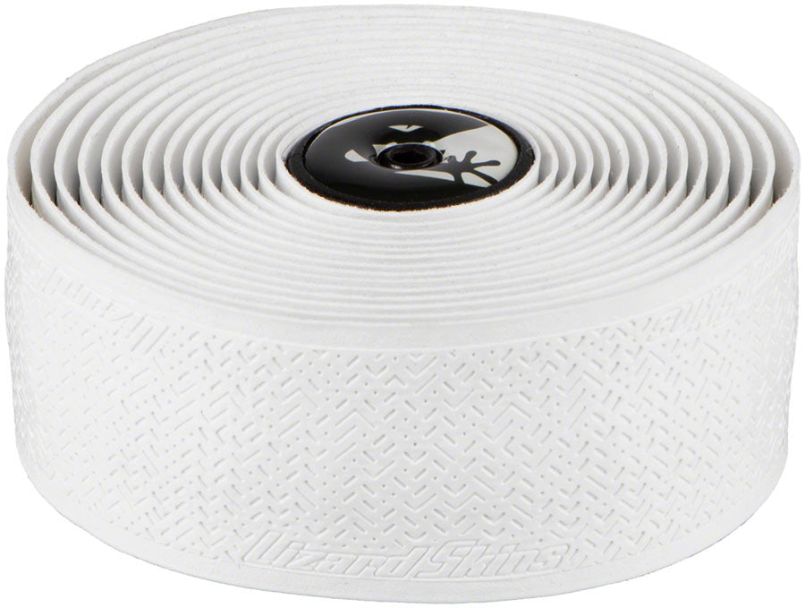 The Lizard Skins DSP Bar Tape V2 - 1.8 MM is a white, textured cycling tape offering shock-absorbing comfort, finished with a black and white end cap featuring a lizard graphic and embossed "Lizard Skins" branding.