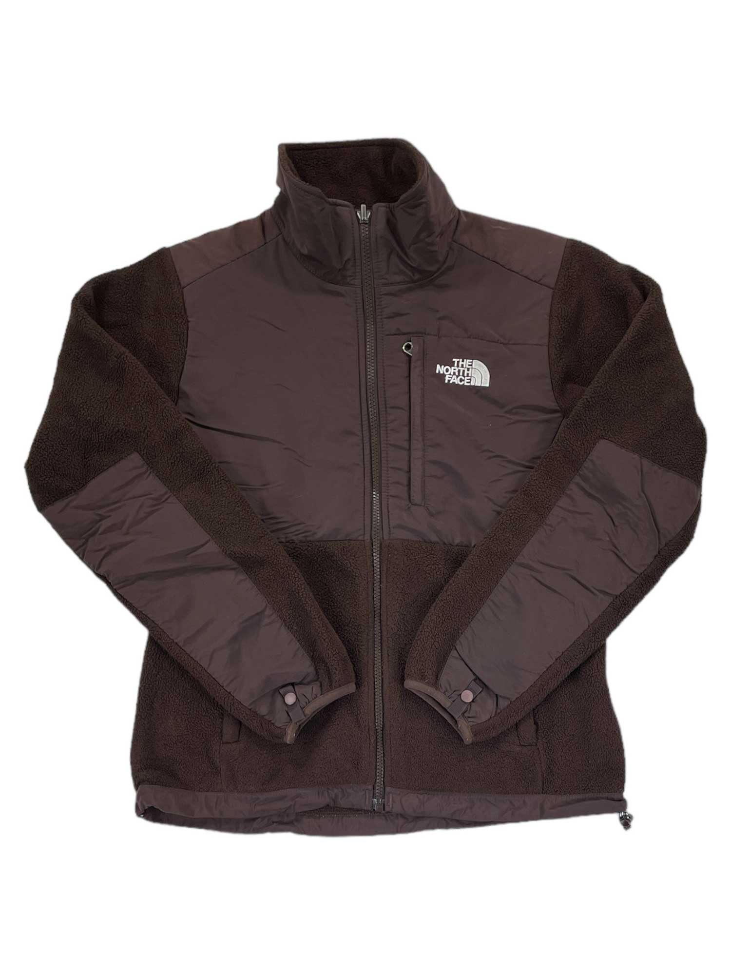 The North Face Denali Fleece Jacket in dark brown features a full front zip, high collar, zippered side pockets, chest and sleeve panels, recycled fleece construction, and the logo on the left chest—ideal for cold weather.