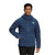 A person in The North Face Men's Belleview Stretch Down Hoodie stands against a plain white background, smiling with one hand in their pocket.
