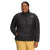 A woman smiles with hands in pockets, wearing The North Face Womens Plus ThermoBall Eco 2.0 black quilted jacket and beige pants, displaying the logo against a plain white background.