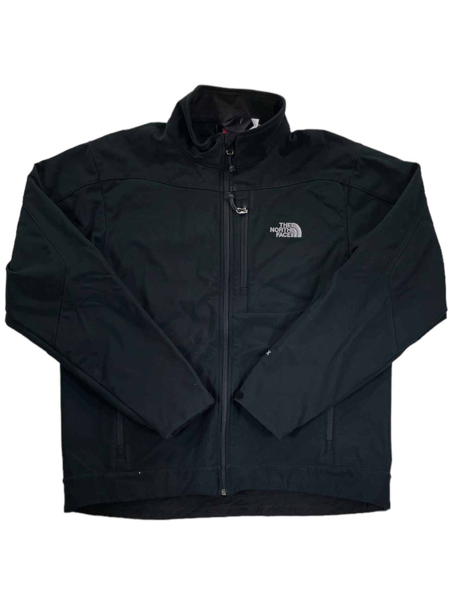 The North Face Apex Bionic Jacket in black features a front zipper, zippered chest pocket, long sleeves, high collar, and signature white logo on the left chest—a sleek men's softshell for any adventure.