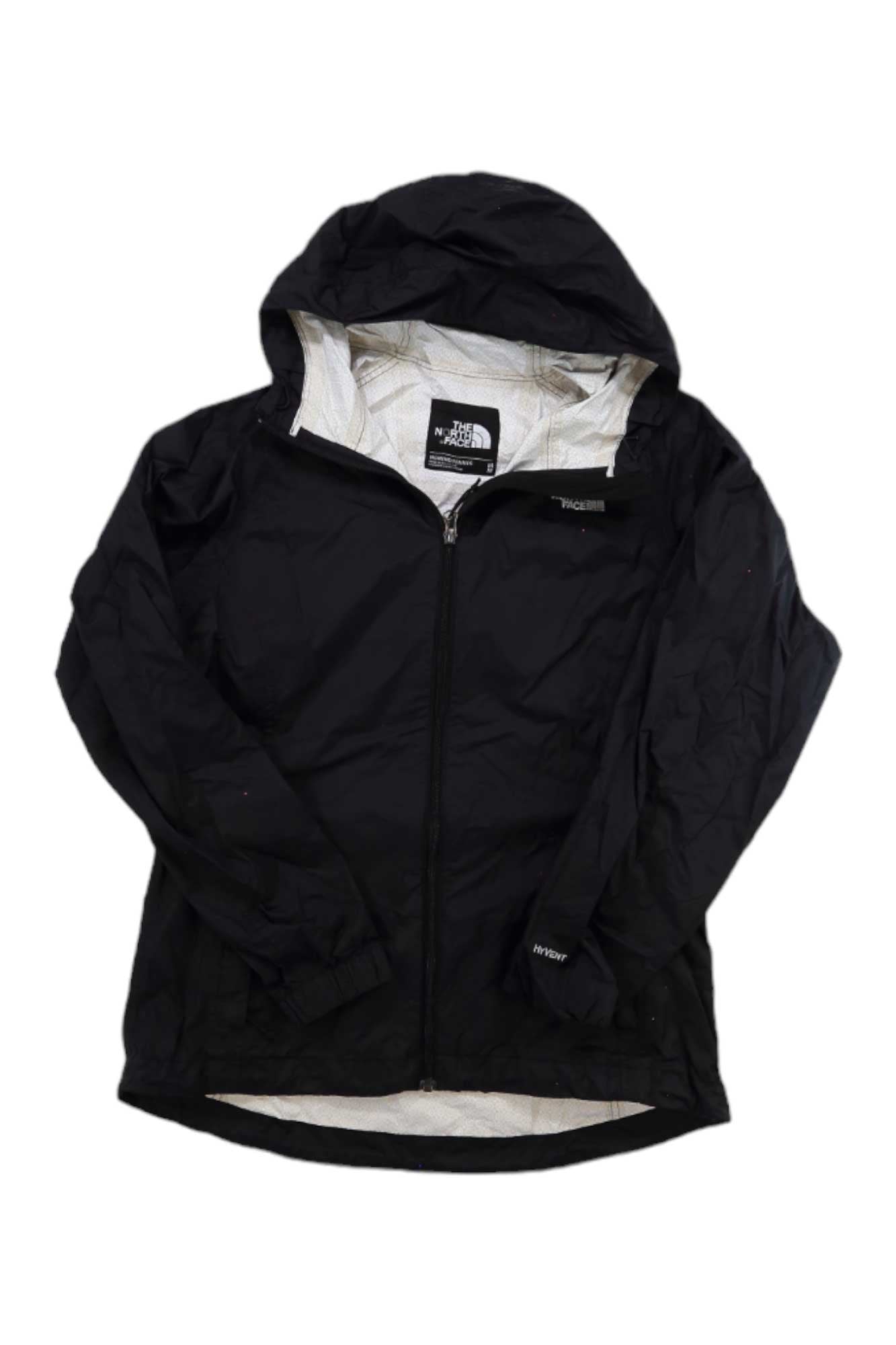 A black Columbia Women's Venture Jacket made from recycled materials, featuring a hood, full front zipper, and the brand logo on the left chest and inner neck label. Long sleeves and a slightly curved hem offer comfort and style.