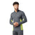 A man wearing the Smartwool Men’s Merino Sport 150 LS 1/4 Zip Top in gray with yellow-green side panels stands with hands clasped, looking aside. The athletic top features a front zipper and is paired with matching gray athletic pants.