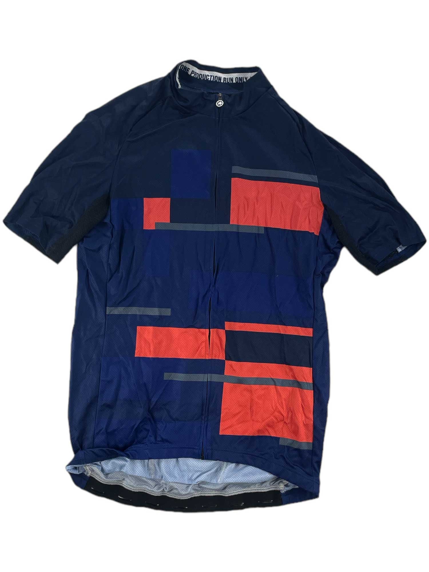 The Short Sleeve Cycling Jersey is a navy blue Assos jersey with red and gray geometric patterns on the front, a full front zipper, small collar, and breathable fabric for comfortable rides.