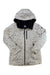 The Burton Womens Lelah Jacket is a white hooded winter jacket with black paint splatter design, black zipper, zippered chest pocket, and black-lined hood, offering an eco-friendly, casual, and artistic style.