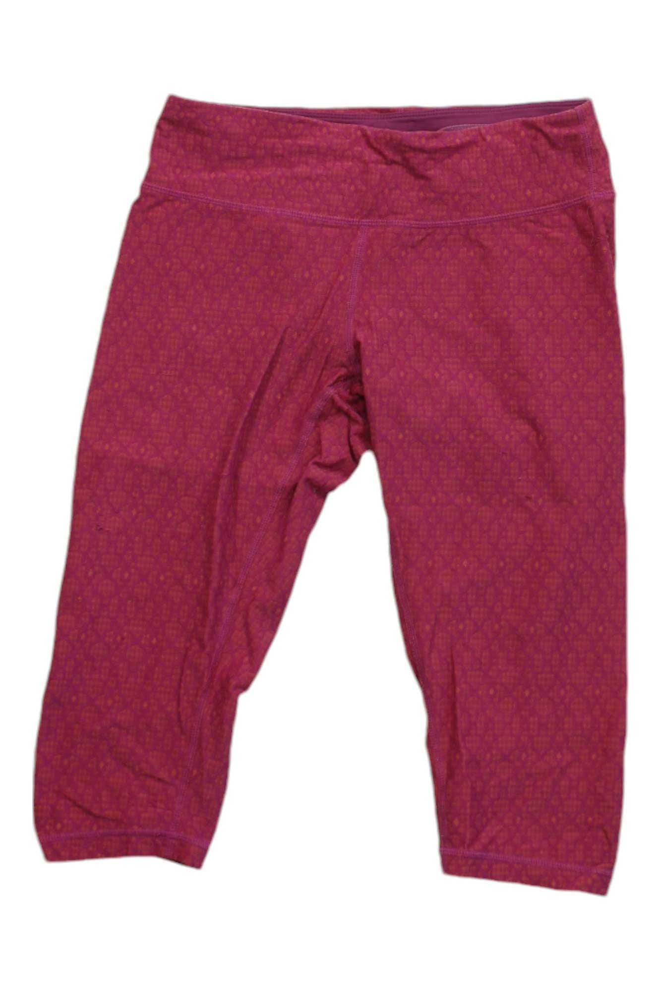 Prana Women's Misty Knickers are pink cropped leggings with a subtle geometric pattern, shown flat on a white background. These women’s hiking leggings offer stylish, moisture-wicking activewear for any adventure.