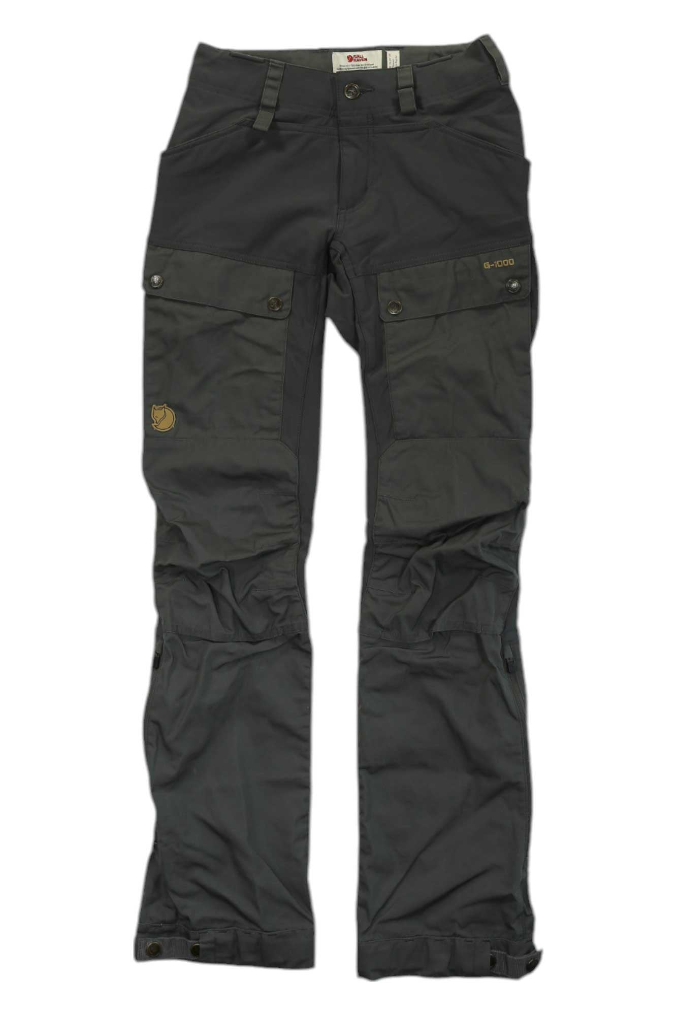 Dark grey Fjallraven Womens Keb Trousers with multiple pockets, G-1000 reinforced knee/thigh areas, buttoned flaps, and a small logo patch on the front left thigh. Pants are laid flat on a white background.