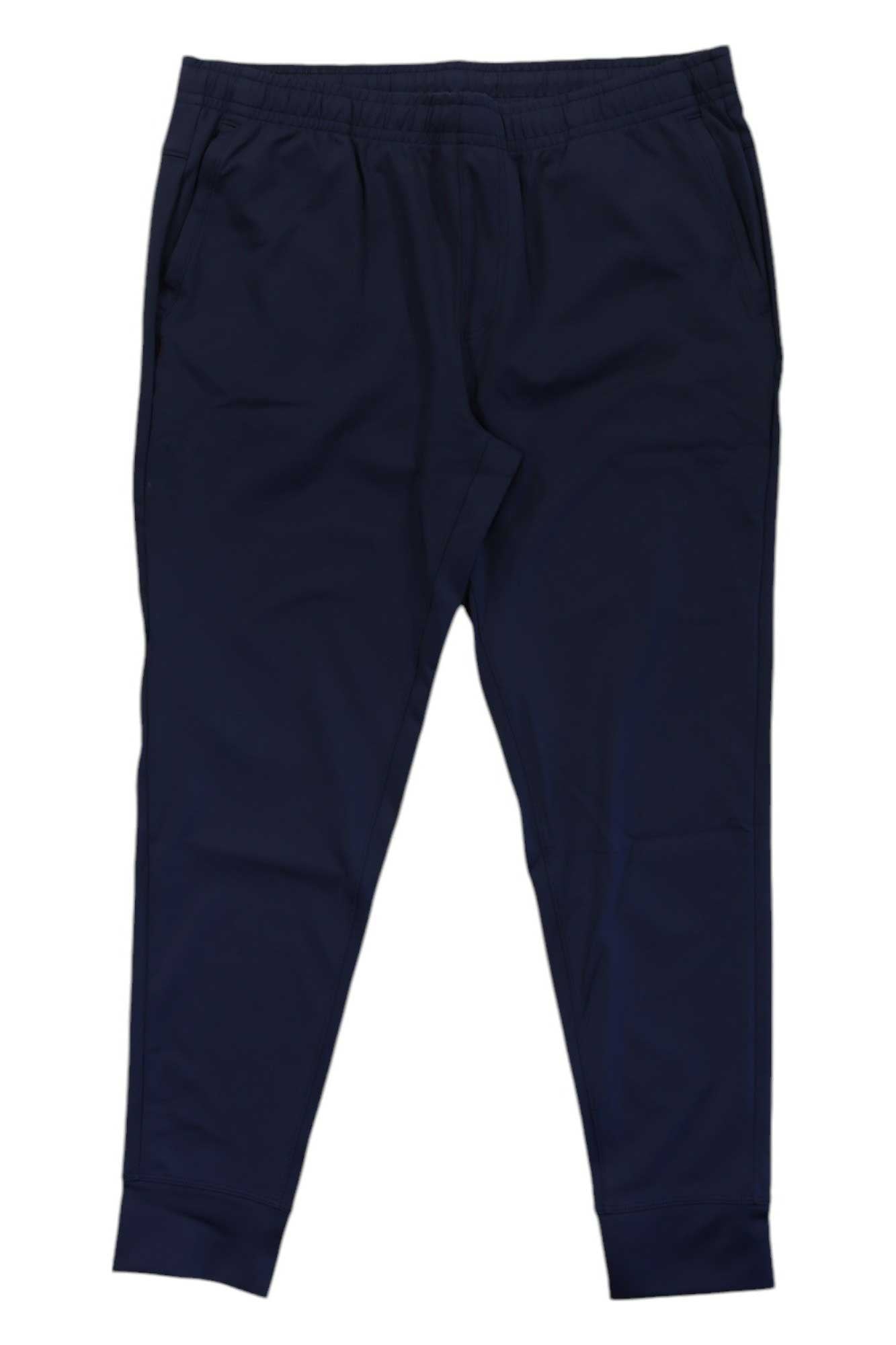 Rhone Men's Spar Jogger in navy blue, featuring an elastic waistband, side pockets, and cuffed ankles. Made from moisture-wicking fabric and displayed flat on a white background.