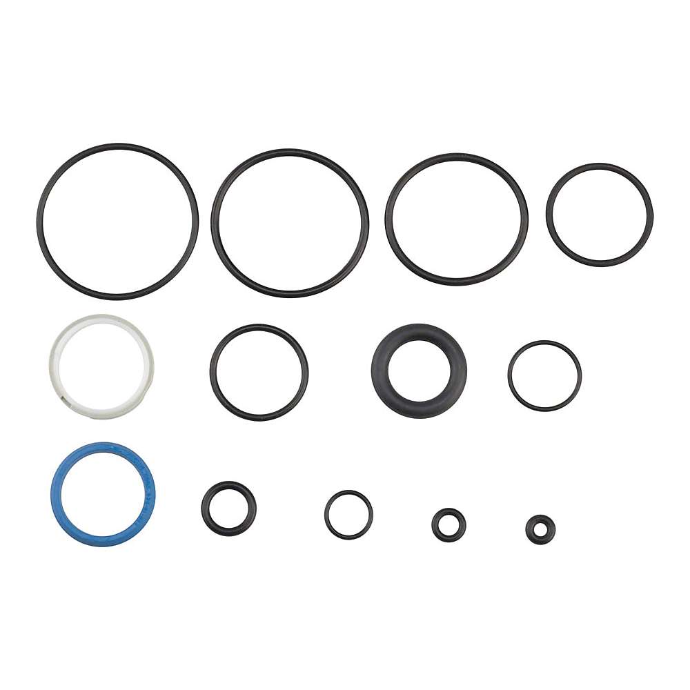 The FOX Cartridge Seal Kit for 32/34 and 36 GRIP Damper Forks includes thirteen assorted O-rings—mostly black, with one blue and one white—arranged in three rows on a white background. Ideal for suspension maintenance.