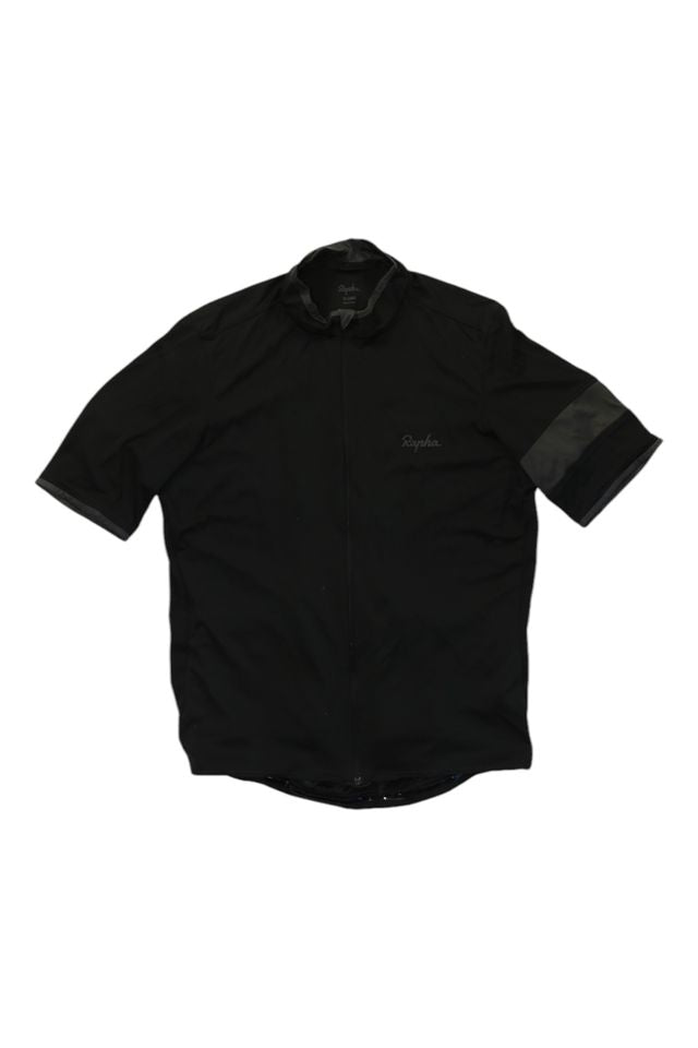 The Rapha Men's Super Lightweight Jersey is a black short-sleeve cycling jersey with a full front zipper, subtle logo on the left chest, and a dark stripe around the left sleeve.