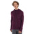 A smiling man with curly hair wears the Icebreaker Mens Quantum III LS Zip Hoodie, dark purple and long-sleeved, paired with gray pants, standing against a plain white background.
