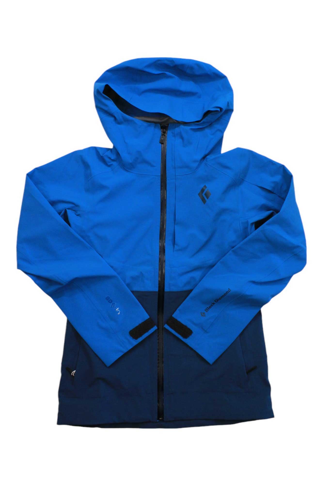 The Black Diamond Womens Recon Stretch Ski Shell Jacket features a bright blue upper, dark navy lower, front zipper, long sleeves, and a small chest logo—ideal as a lightweight ski shell for women on the slopes.