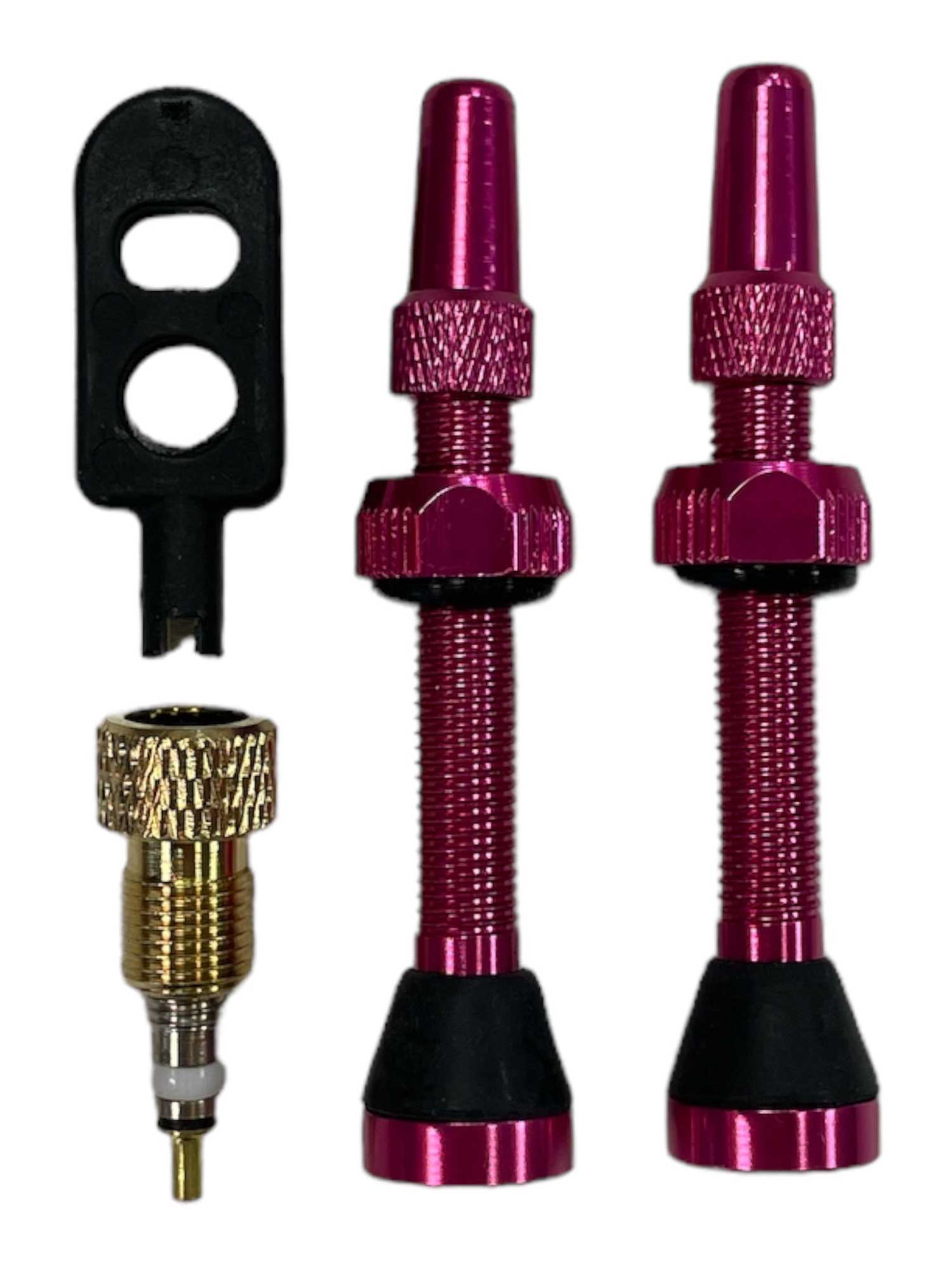 Two pink Serfas Tubeless Presta Valves with black rubber bases, a brass valve core, and a black plastic valve core remover tool are arranged on a white background—ideal for cycling.